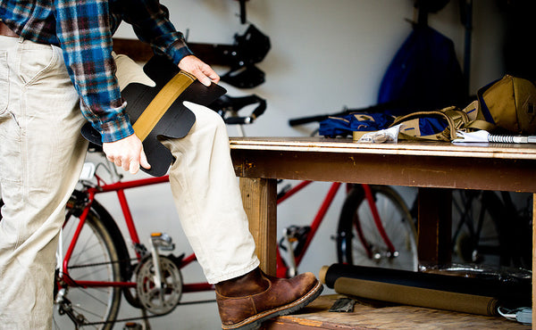 A person adjusting the removeable frame sheet with their knee.